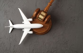 A model of an airplane and a judge's gavel on a desk of and airplane defect injuries lawyer